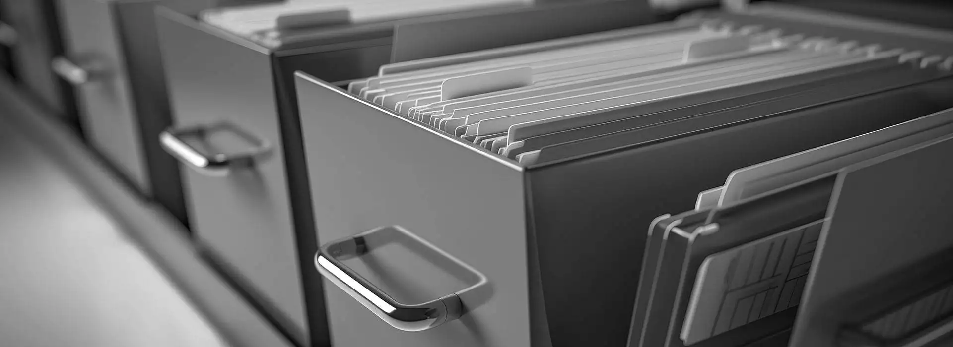 A black and white photo of a stack of file folders.