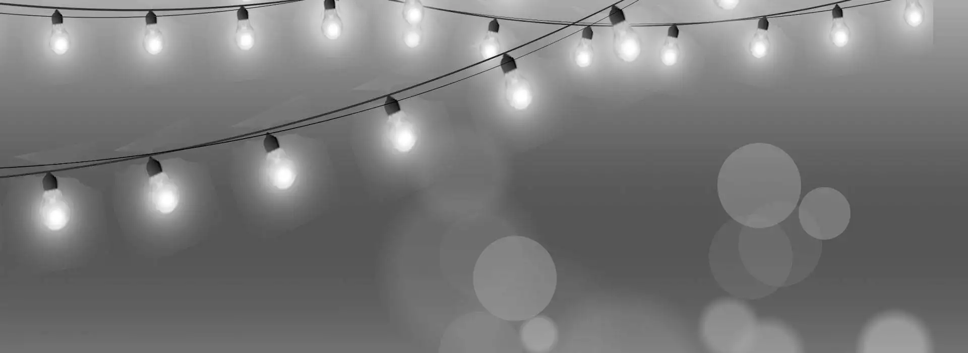 Christmas lights on a gray background with bokeh.