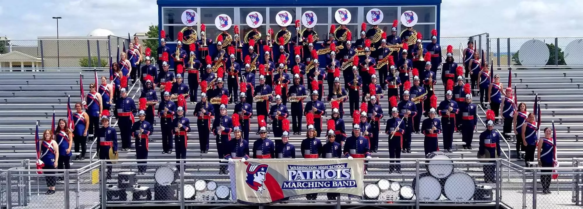 A group of marching band members posing for a picture.